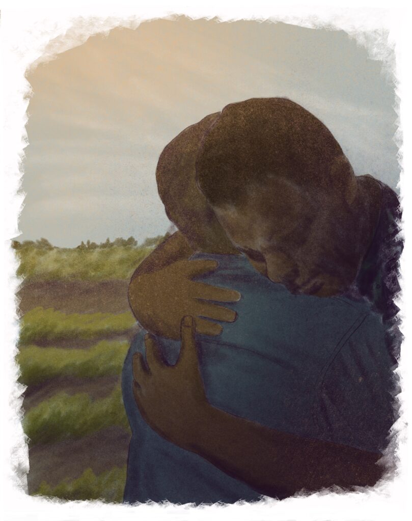 Two people hugging with a field in the background